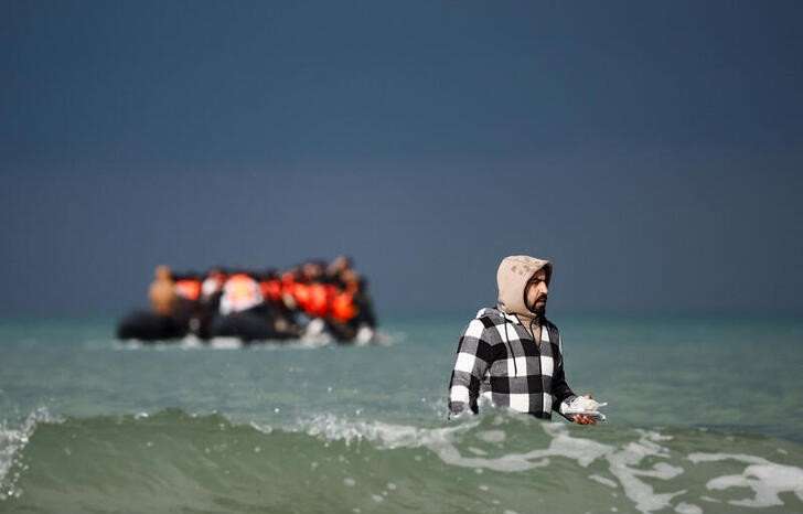 Migrants attempt to cross the English Channel, on the beach of the Slack dunes in Wimereux