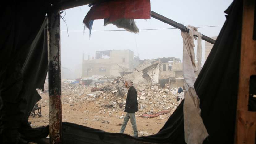 Palestinians inspect the damage to a tent for displaced people, after an Israeli airstrike, in Khan Younis