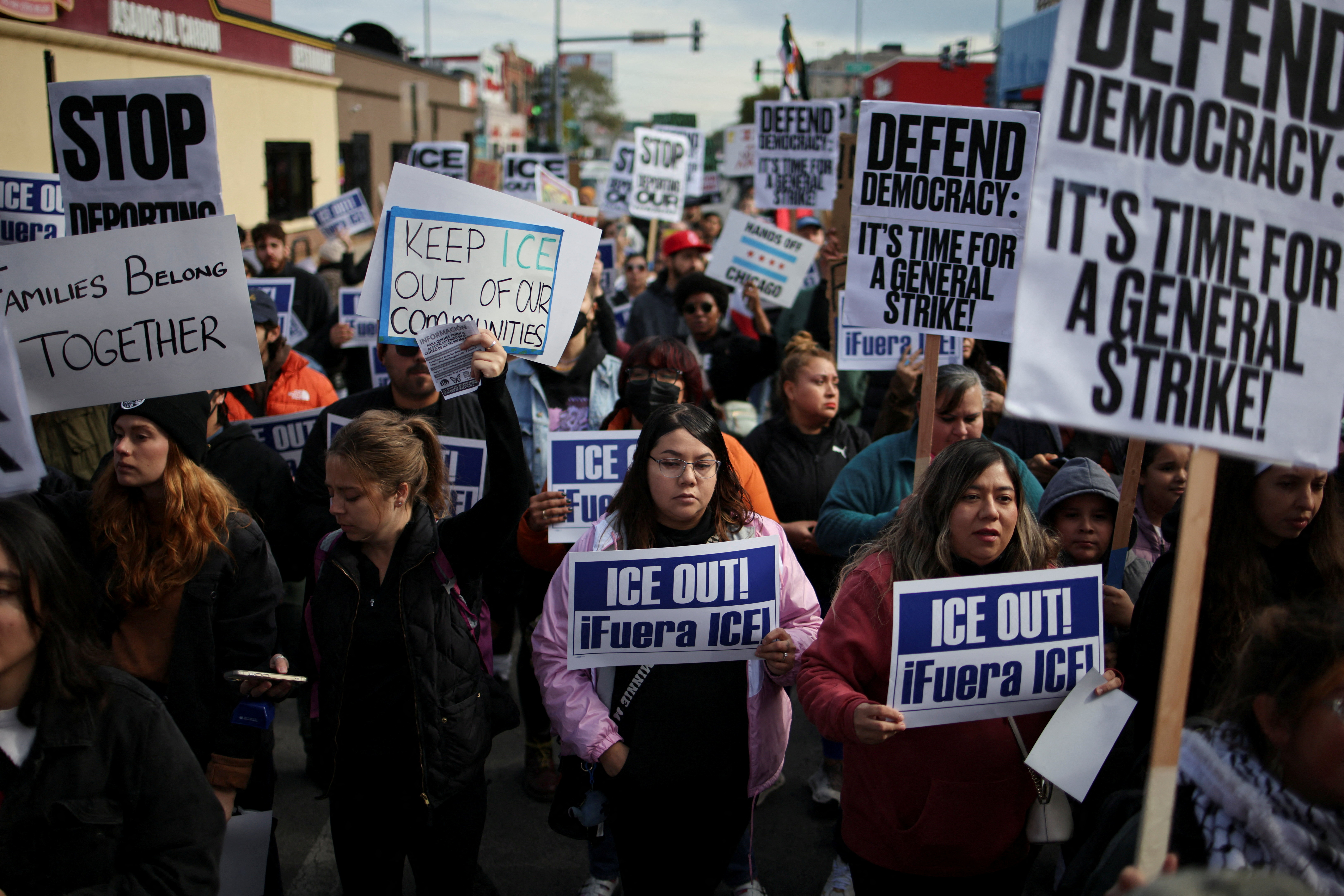 FILE PHOTO: People gather for a protest against ICE raids in Little Village, Chicago