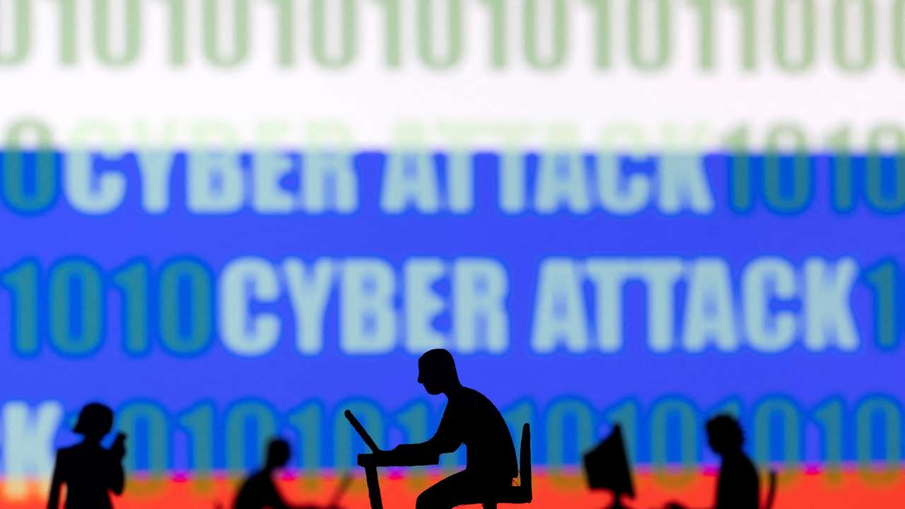 Illustration shows figurines with computers and smartphones in front of Russia flag