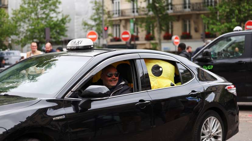 French taxi drivers gather for a strike protesting over proposed government cuts to cash for ferrying patients to and from medical appointments, in Paris