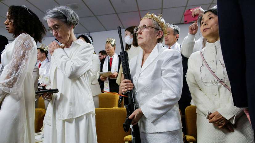 FILE PHOTO: A woman holds her AR-15-style rifle as people attend a blessing ceremony with their AR-15-style rifles in their cases at the Sanctuary Church in Newfoundland