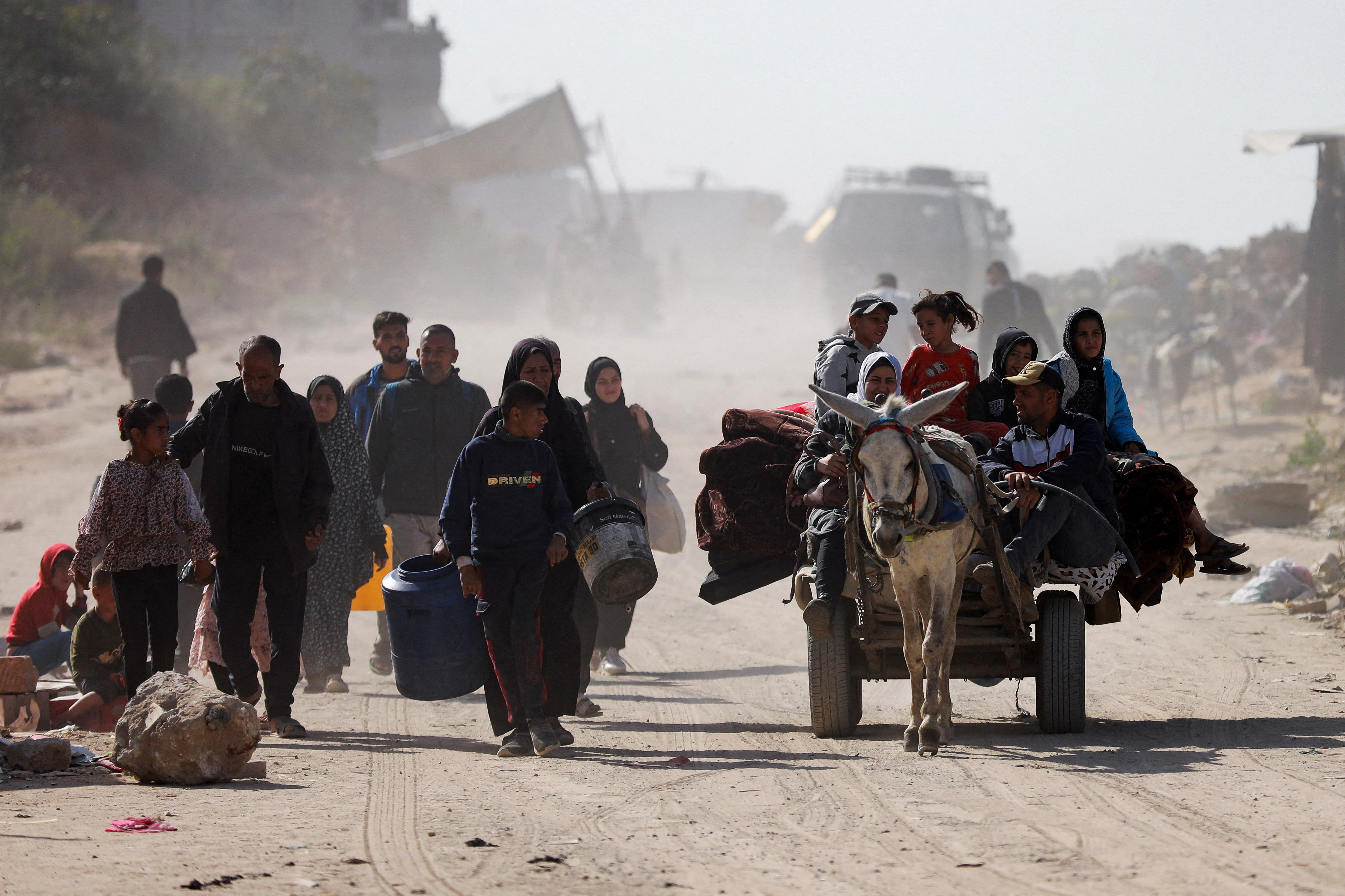 Palestinians make their way to flee their homes, after the Israel army issued evacuation orders for a number of neighborhoods, following heavy Israeli strikes, in Beit Lahiya