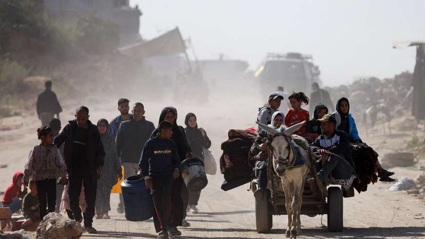 Palestinians make their way to flee their homes, after the Israel army issued evacuation orders for a number of neighborhoods, following heavy Israeli strikes, in Beit Lahiya