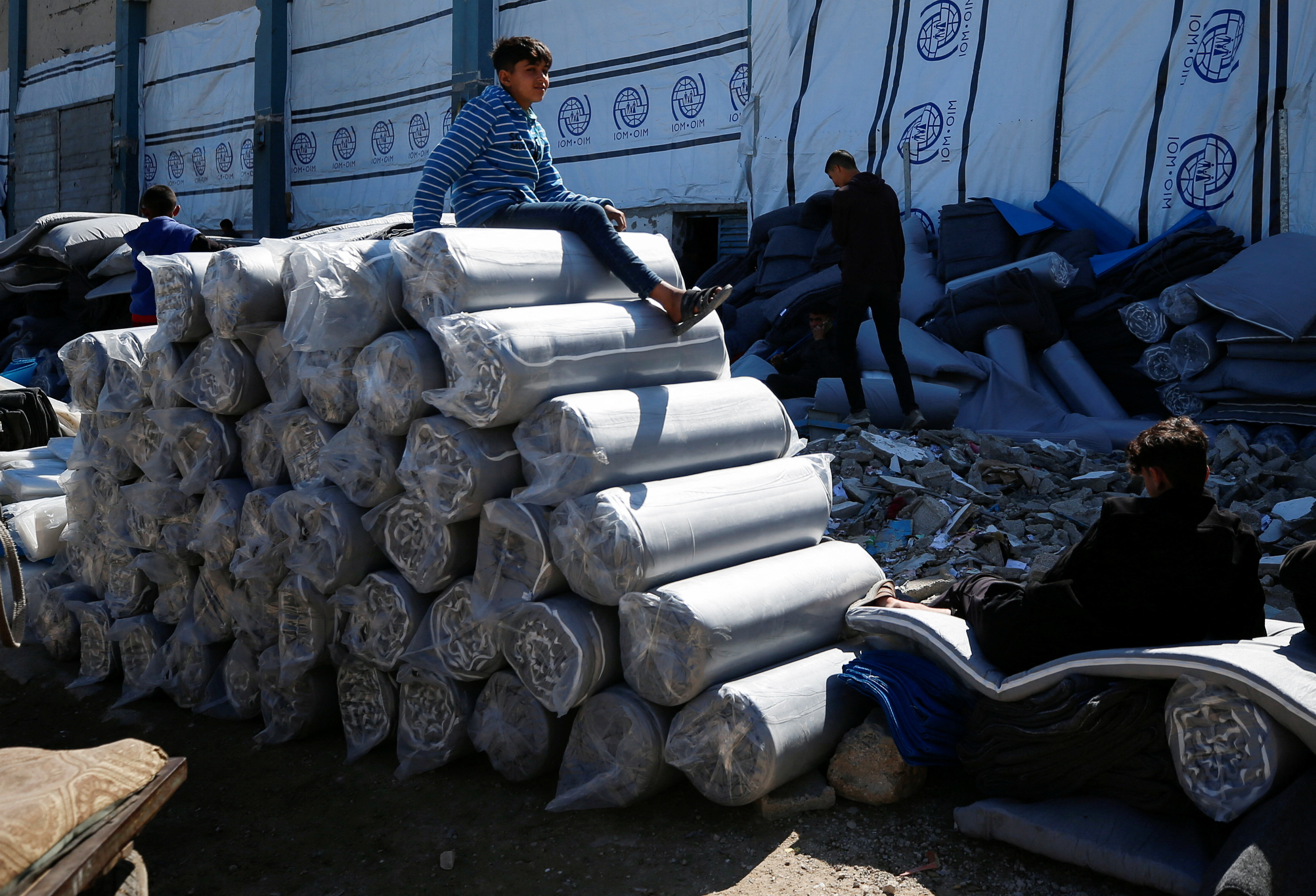 Palestinians gather to receive aid, at Jabalia refugee camp in northern Gaza Strip