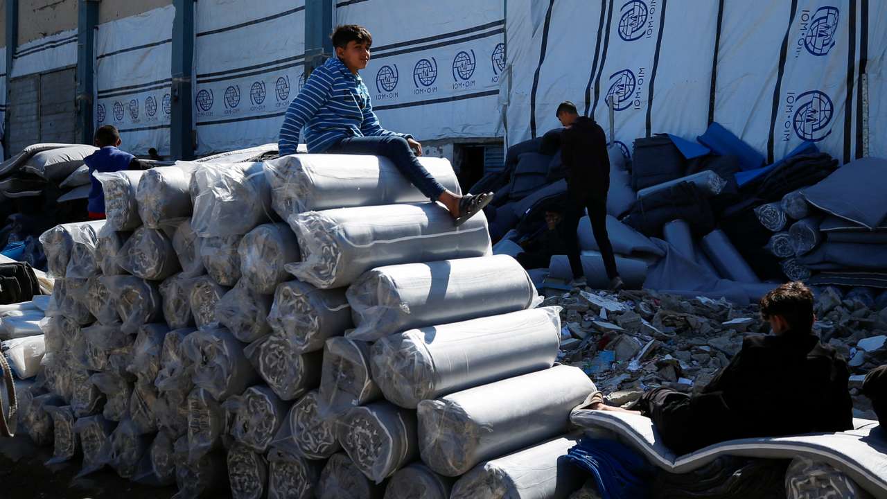 Palestinians gather to receive aid, at Jabalia refugee camp in northern Gaza Strip