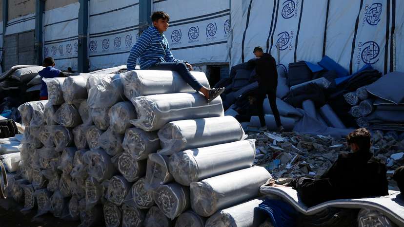 Palestinians gather to receive aid, at Jabalia refugee camp in northern Gaza Strip