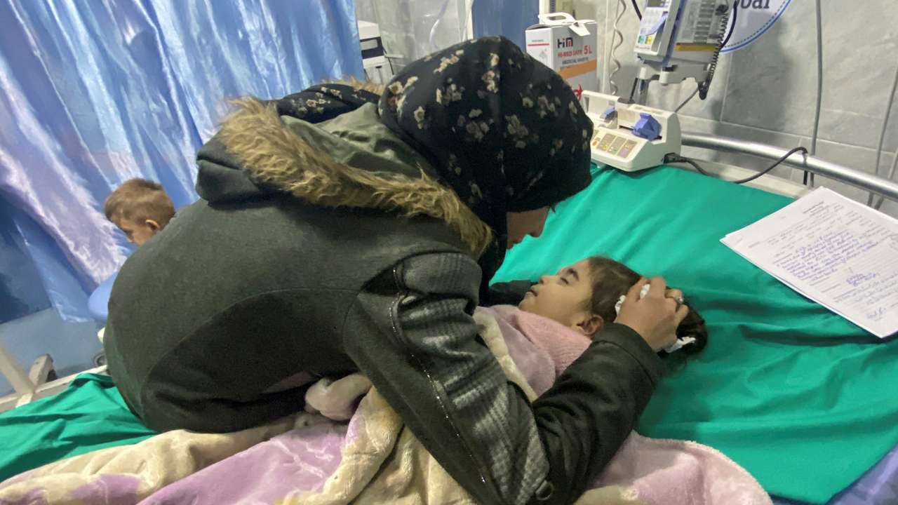 Palestinian mother Anwar Abdulnabi cries over the body of her daughter Mila, who had been suffering from deficiencies of calcium and potassium, at Kamal Adwan hospital on the edges of Beit Lahiya, in the northern Gaza Strip