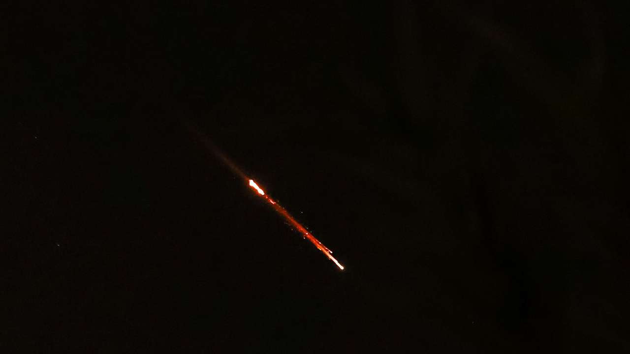 Objects are seen in the sky above Jerusalem after Iran launched drones and missiles towards Israel, in Jerusalem