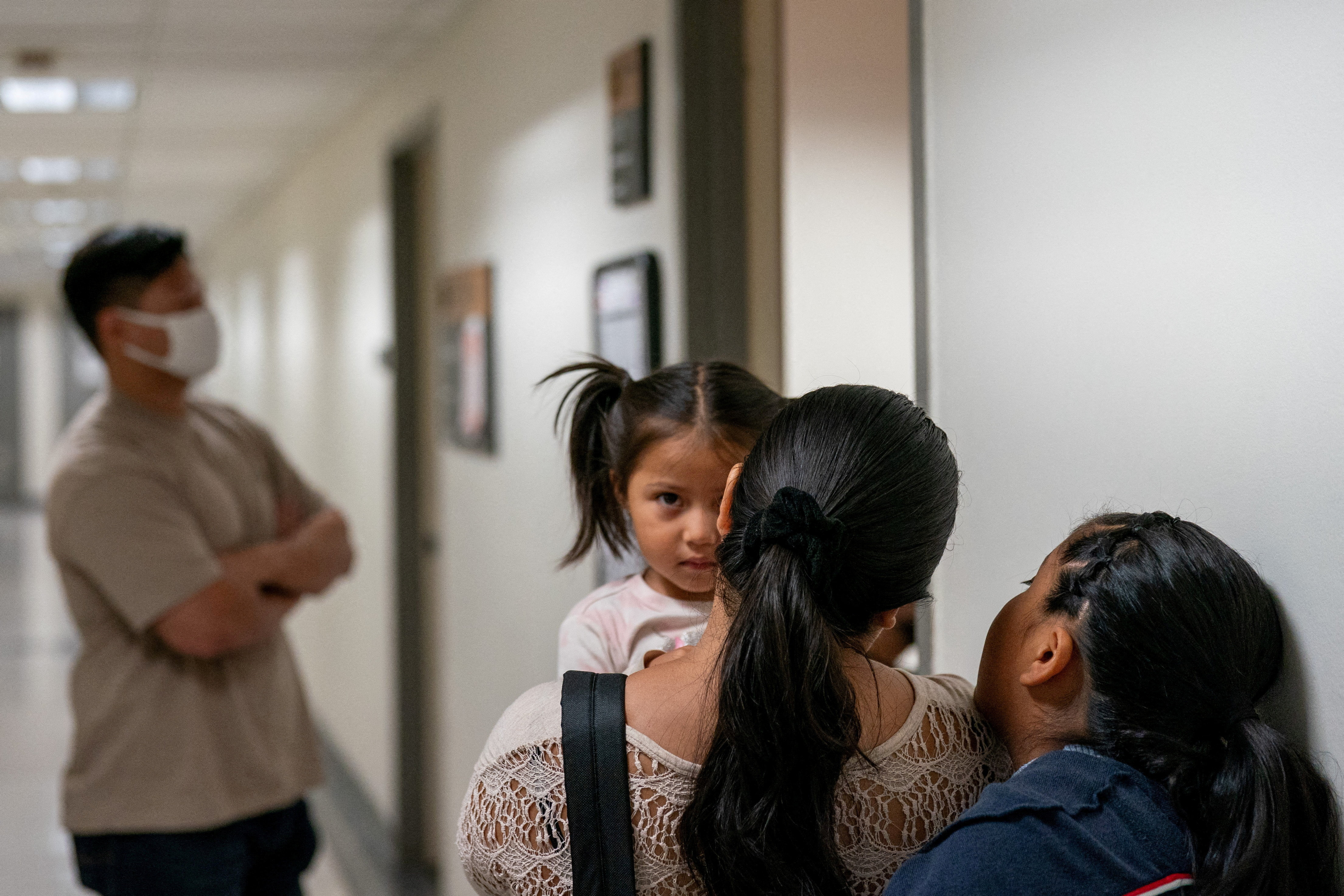 A migrant is detained by federal immigration officers at U.S. immigration court
