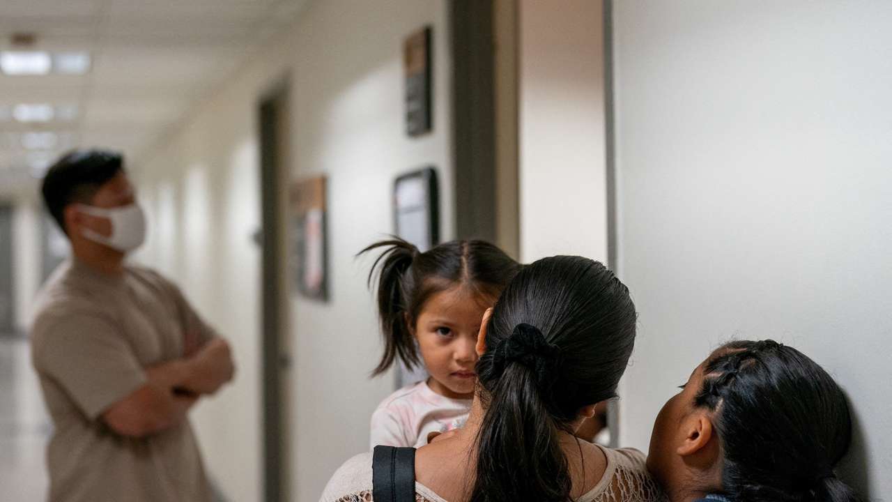 A migrant is detained by federal immigration officers at U.S. immigration court
