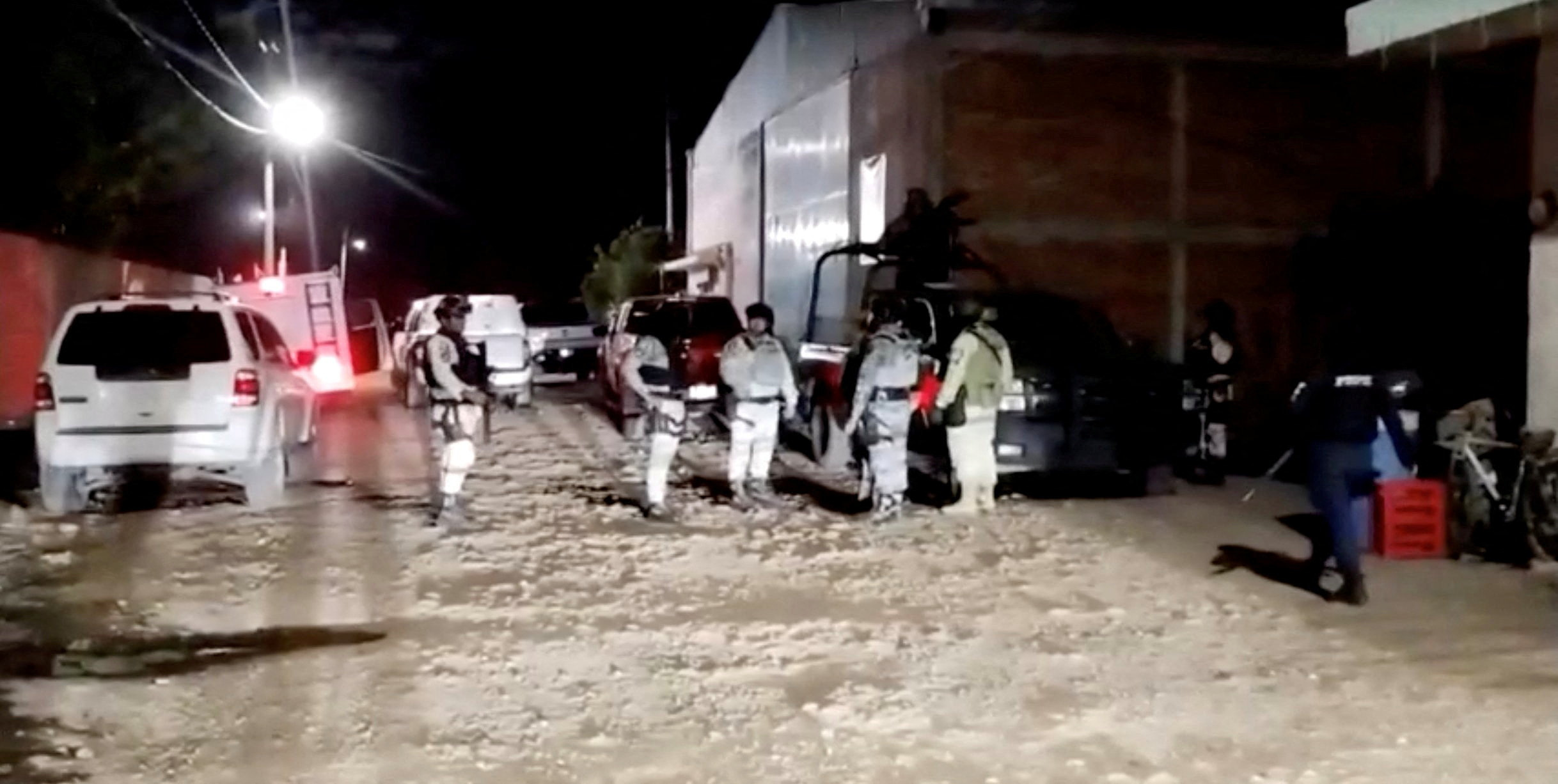 Security personnel work at the site where a group of armed attackers killed several people at a soccer sports field after a match in Salamanca