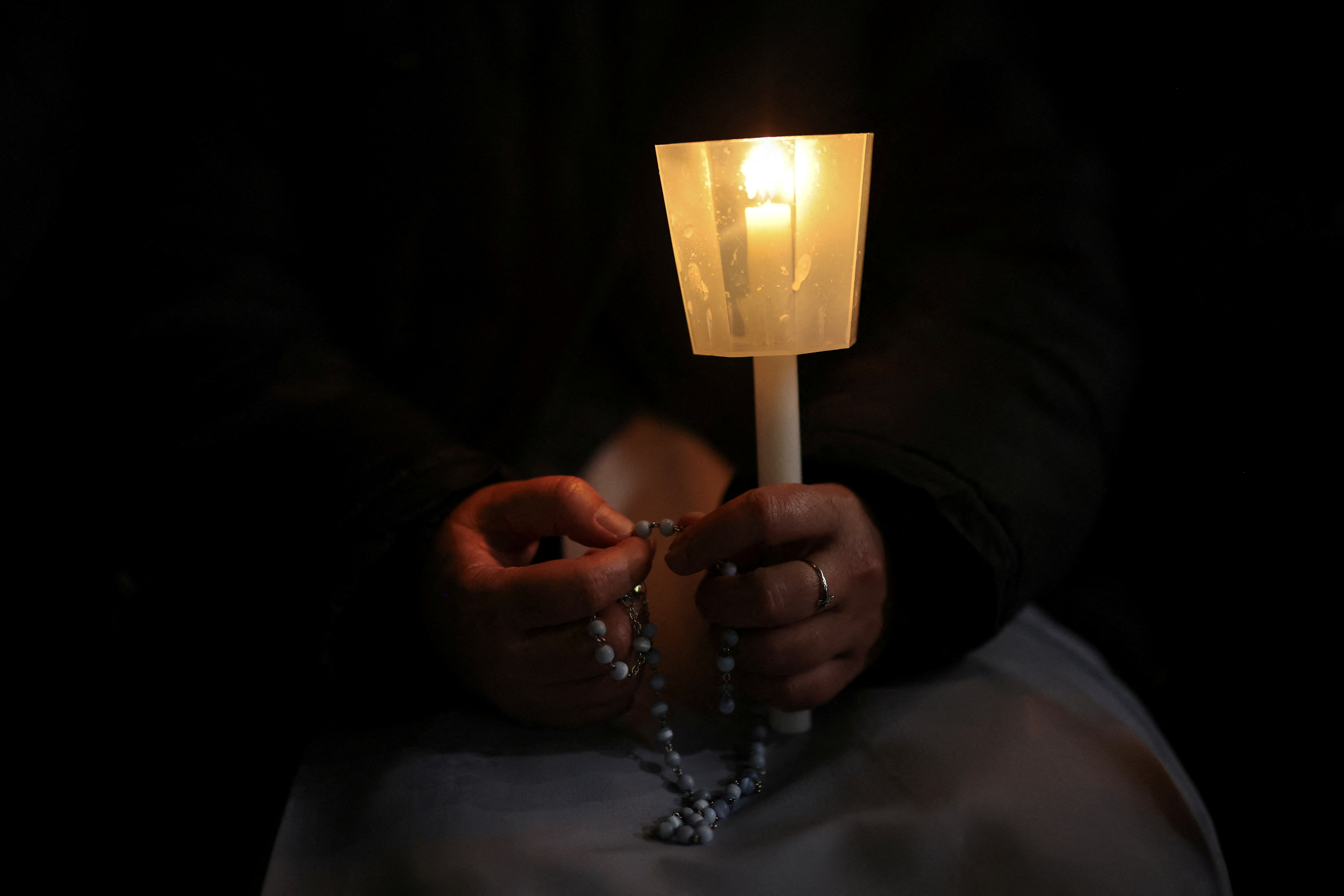 People pray as Pope Francis continues hospitalisation, at the Vatican