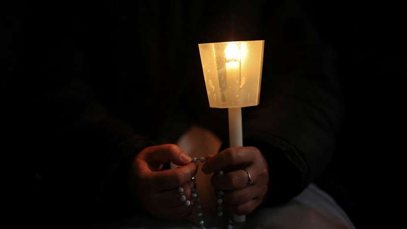 People pray as Pope Francis continues hospitalisation, at the Vatican