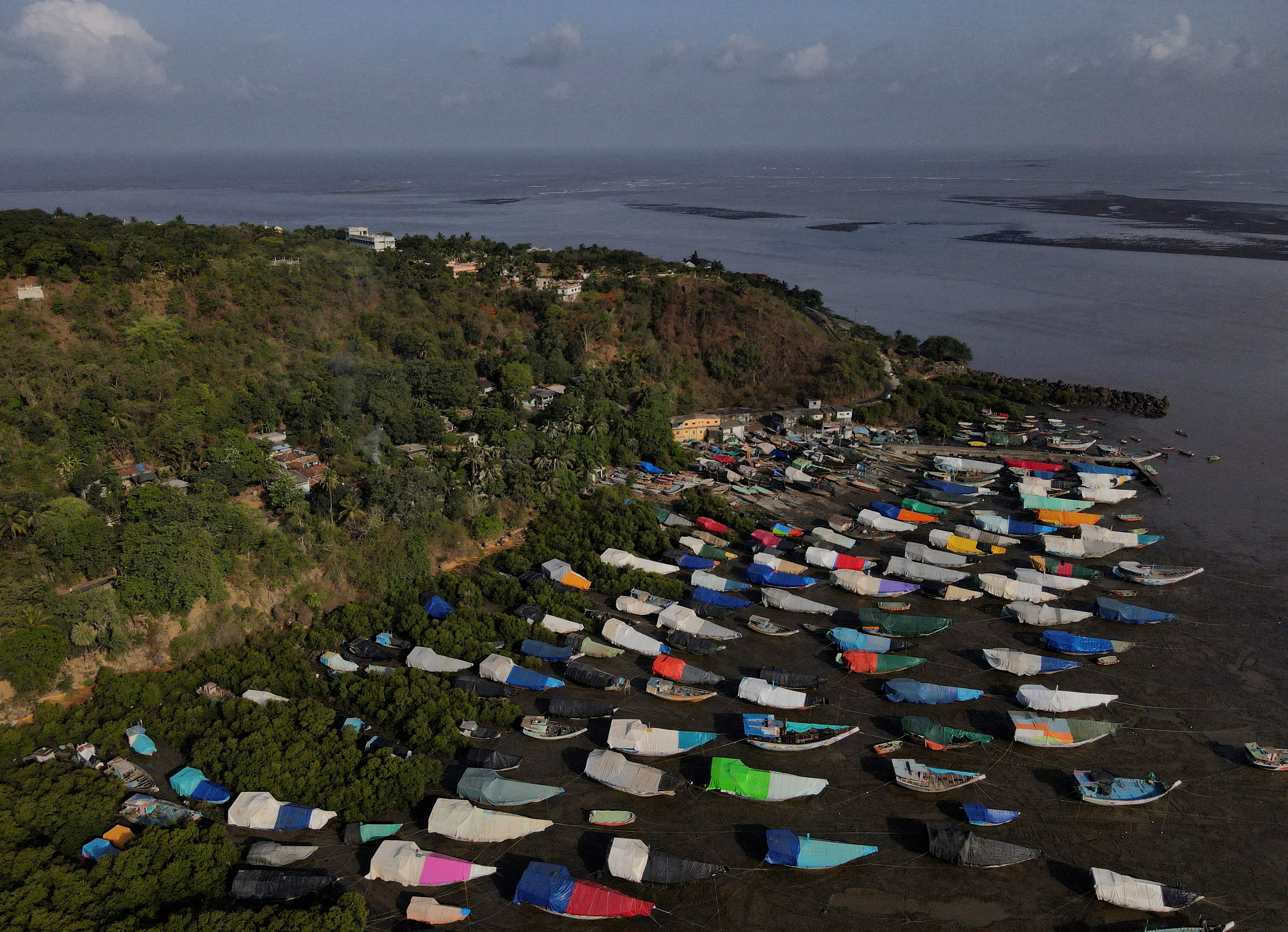 FILE PHOTO: An aerial view of fishing boats covered with tarpaulin sheets parked on the shore, before the start of the monsoon season, on the outskirts of Mumbai