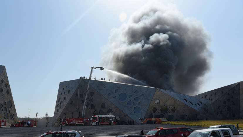 Firefighters work to contain a large fire at Jaber Al Ahmad Cultural Centre in Kuwait City