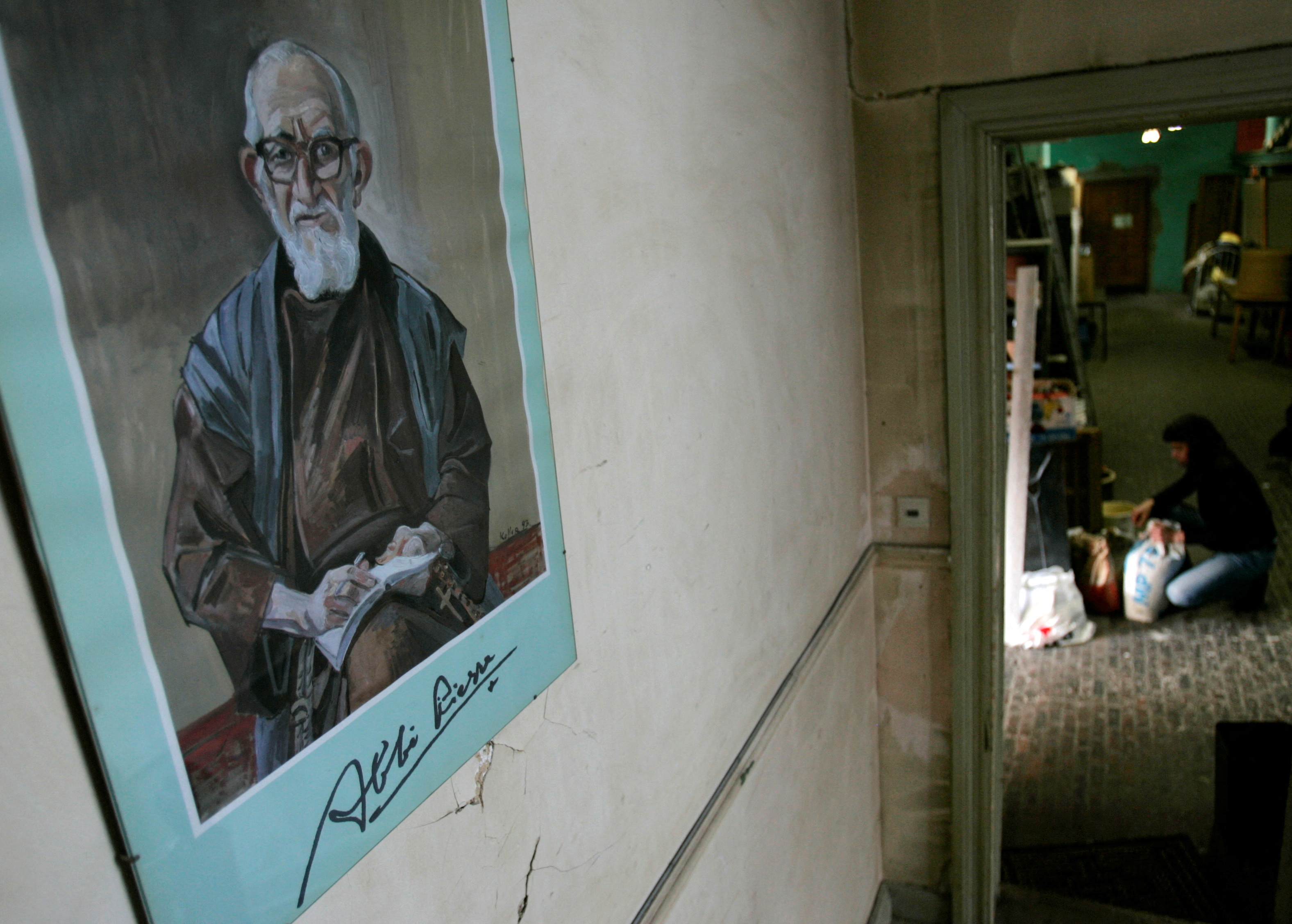 FILE PHOTO: A portrait of French priest Pierre hangs on a wall at La poudriere centre in Brussels