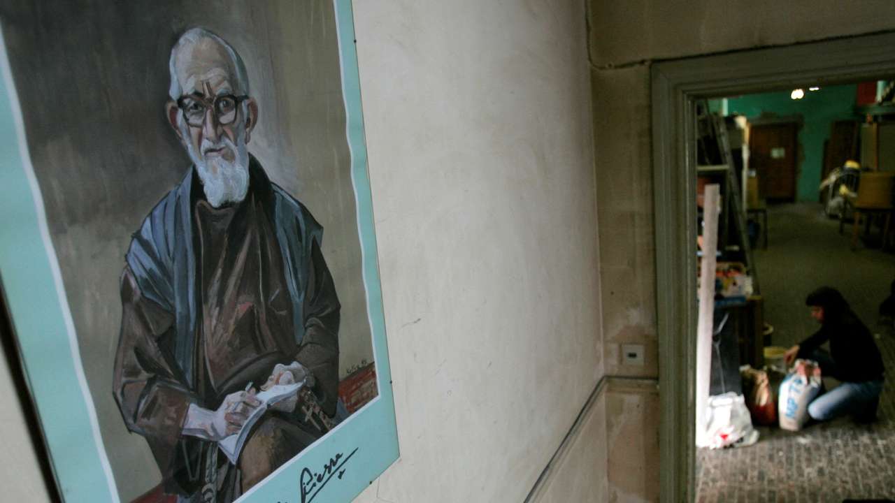 FILE PHOTO: A portrait of French priest Pierre hangs on a wall at La poudriere centre in Brussels