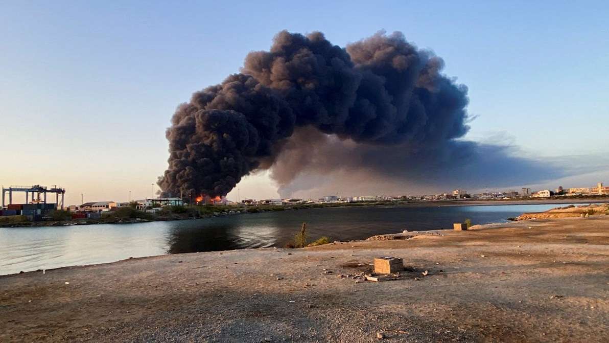 A view shows a large plume of smoke rising from fuel depot in Port Sudan