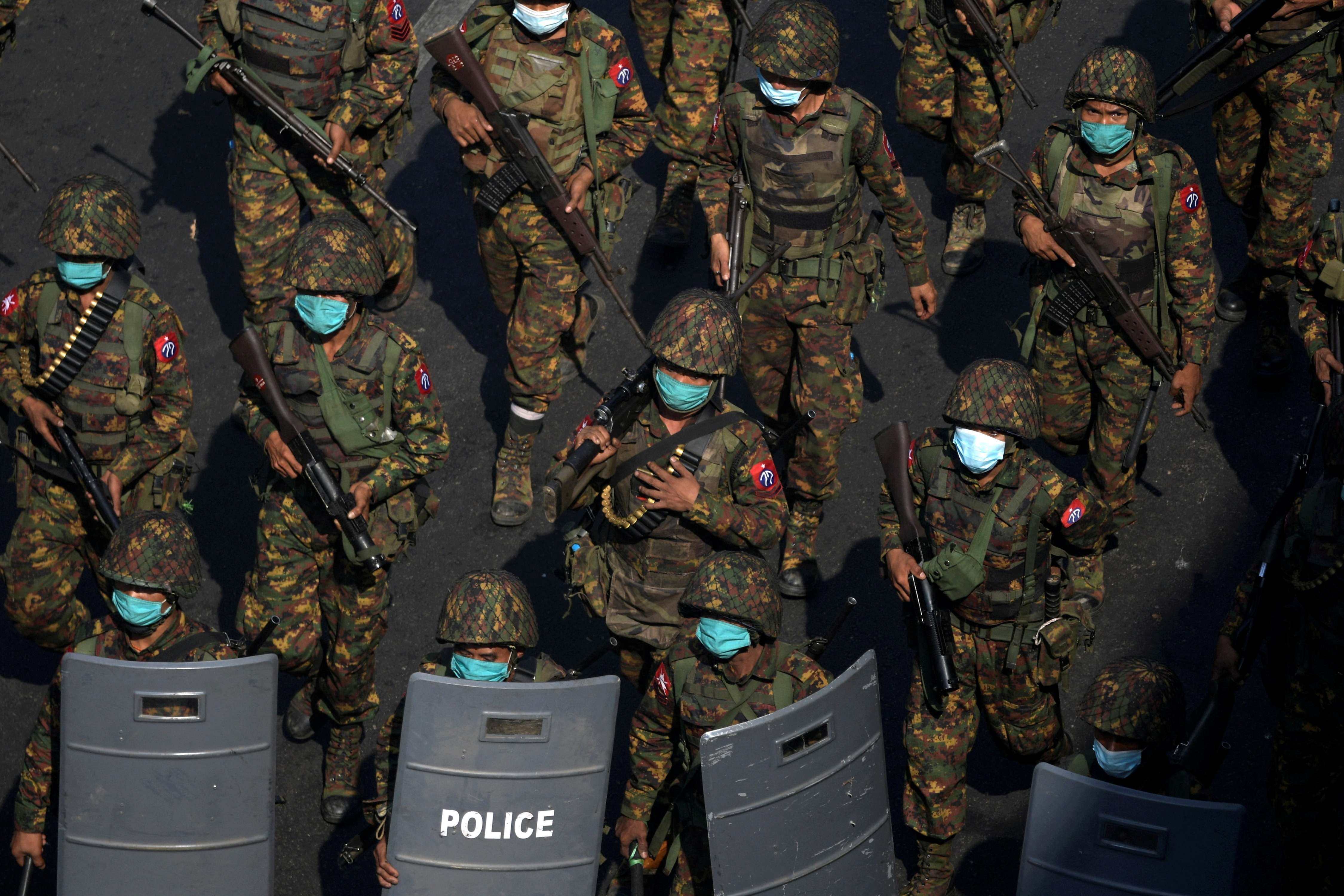 FILE PHOTO: Myanmar soldiers walk along a street during a protest against the military coup in Yangon