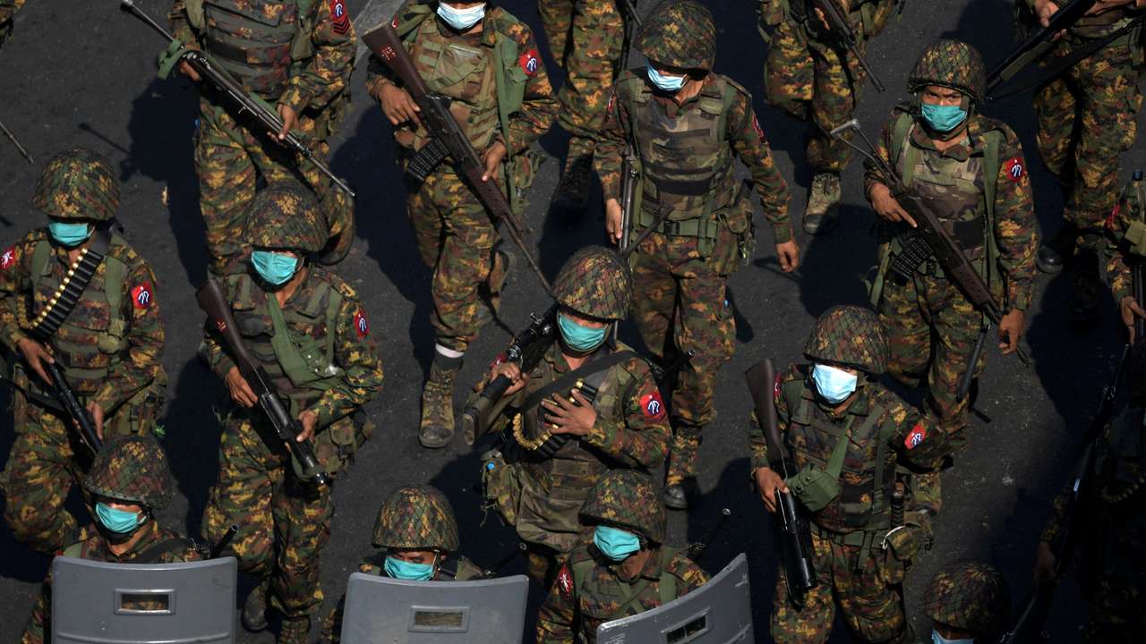 FILE PHOTO: Myanmar soldiers walk along a street during a protest against the military coup in Yangon