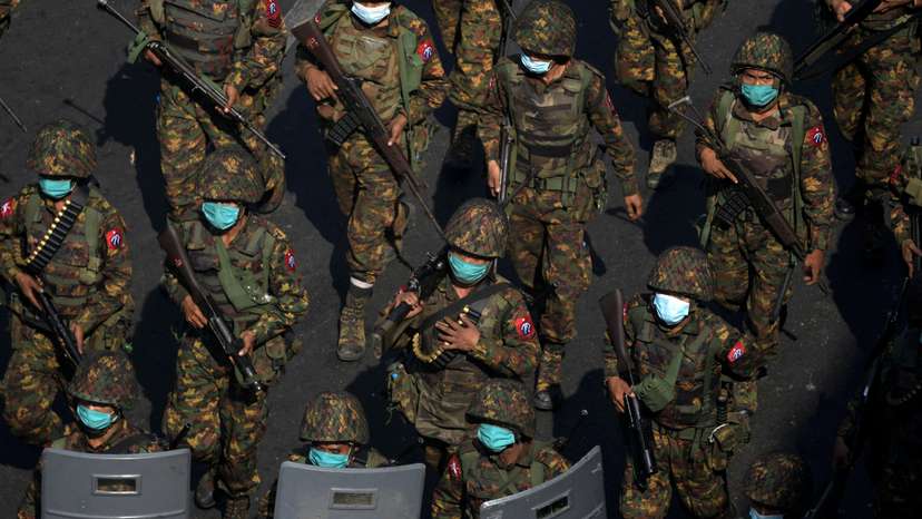 FILE PHOTO: Myanmar soldiers walk along a street during a protest against the military coup in Yangon