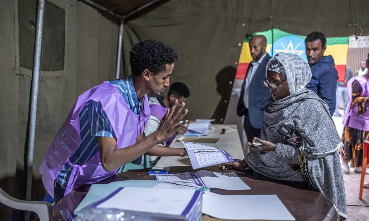 A National Election Board of Ethiopia (NEBE) official explains voting procedures to a voter at Shalla Park polling station in Addis Ababa, on June 1, 2026, during the 2026 Ethiopian parliamentary elections. Ethiopians began voting on June 1, 2026 in parliamentary elections, with the party of outgoing Prime Minister Abiy Ahmed, who is running for another term, expected to win.
Around 50 million voters are eligible to vote in the election for members of parliament, who will in turn select the prime minister. (Photo by Marco Simoncelli / AFP)