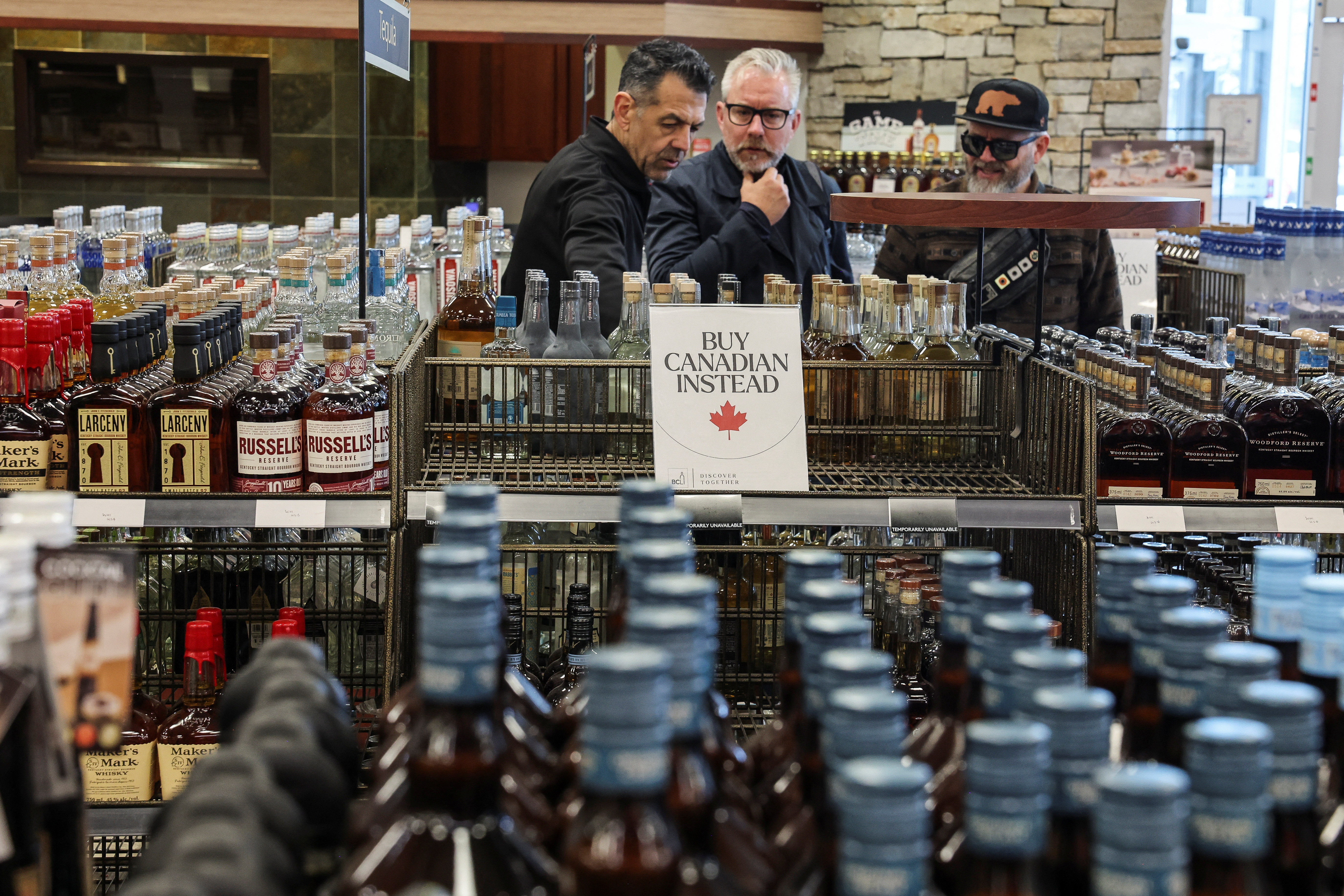 Empty shelves remain with signs ''Buy Canadian Instead'' after the top five U.S. liquor brands were removed from sale at a B.C. Liquor Store, in Vancouver