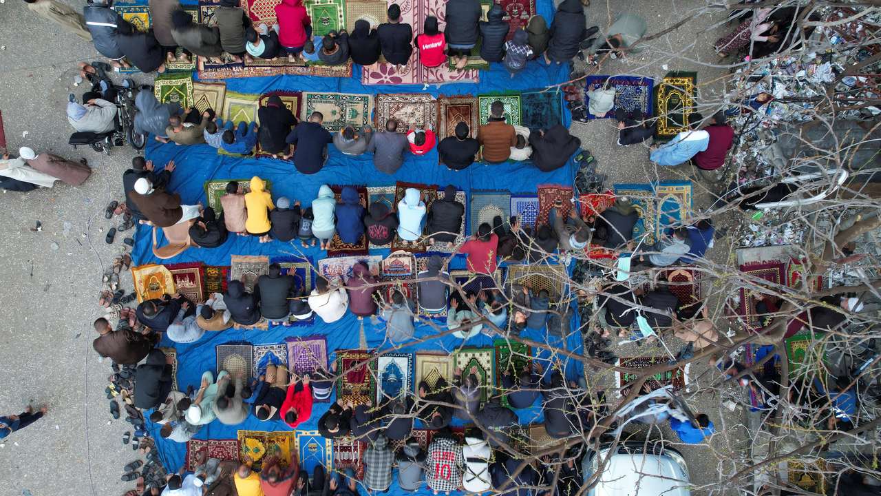 Palestinians hold Eid al-Fitr prayers by the ruins of al-Farouk mosque in Rafah