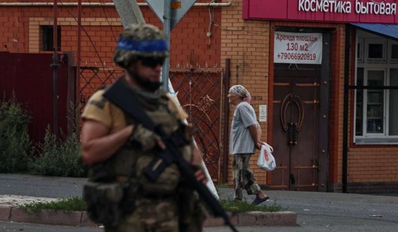 A Ukrainian serviceman patrols in the town of Sudzha