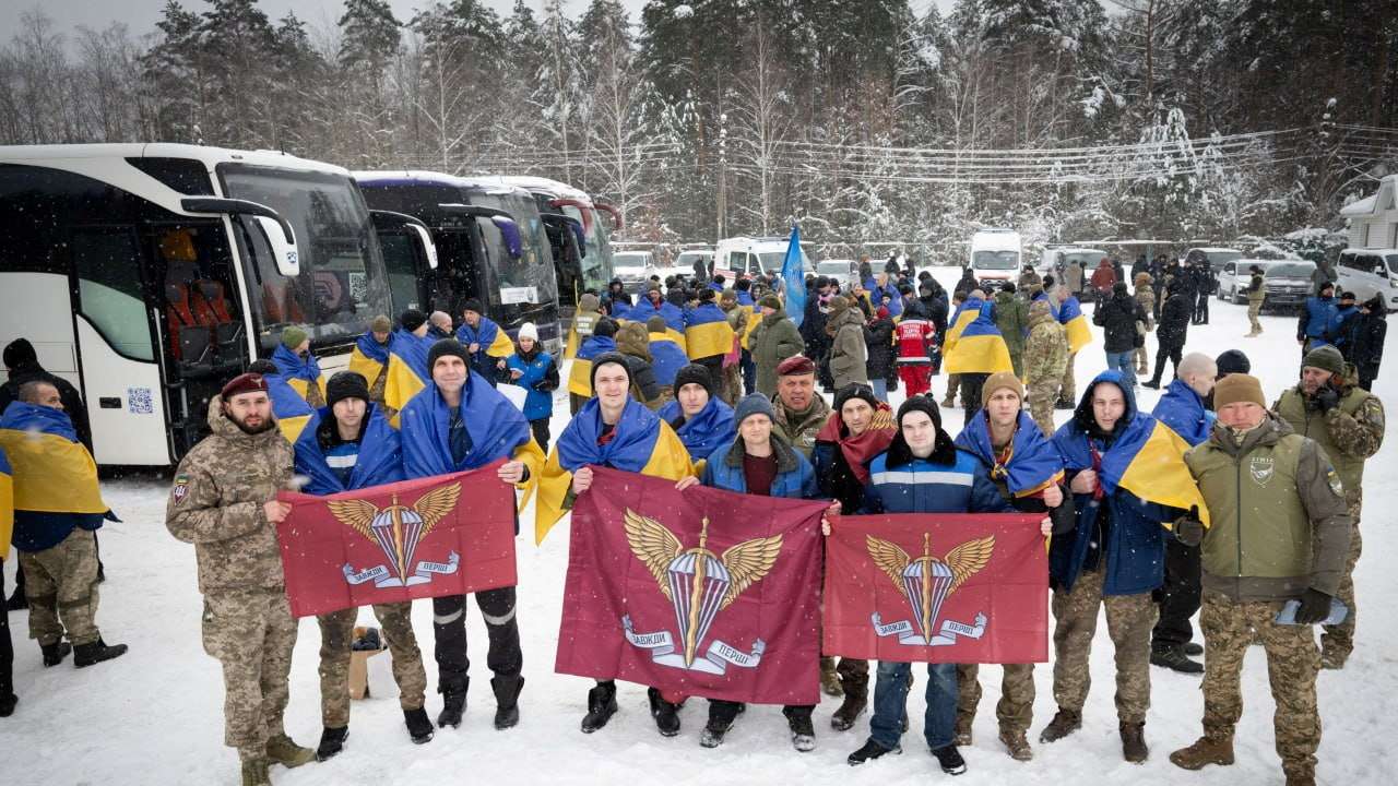 Ukrainian prisoners of war (POWs) pose for a picture after a swap at an undisclosed location in Ukraine