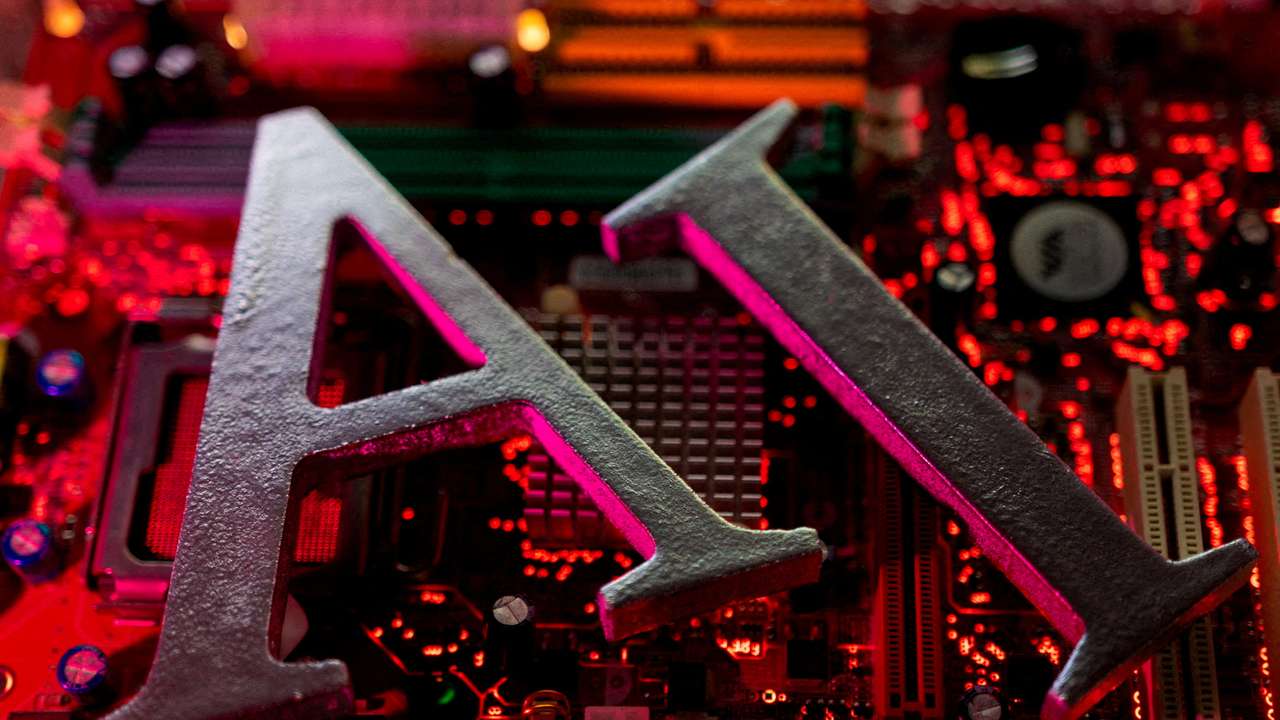 FILE PHOTO: Illustration shows AI (Artificial Intelligence) letters and computer motherboard