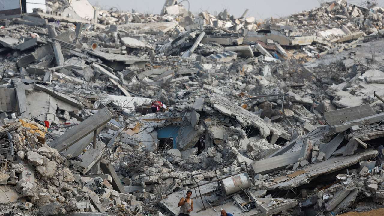Palestinians work amid the rubble of destroyed buildings, during a ceasefire between Israel and Hamas, in Jabalia