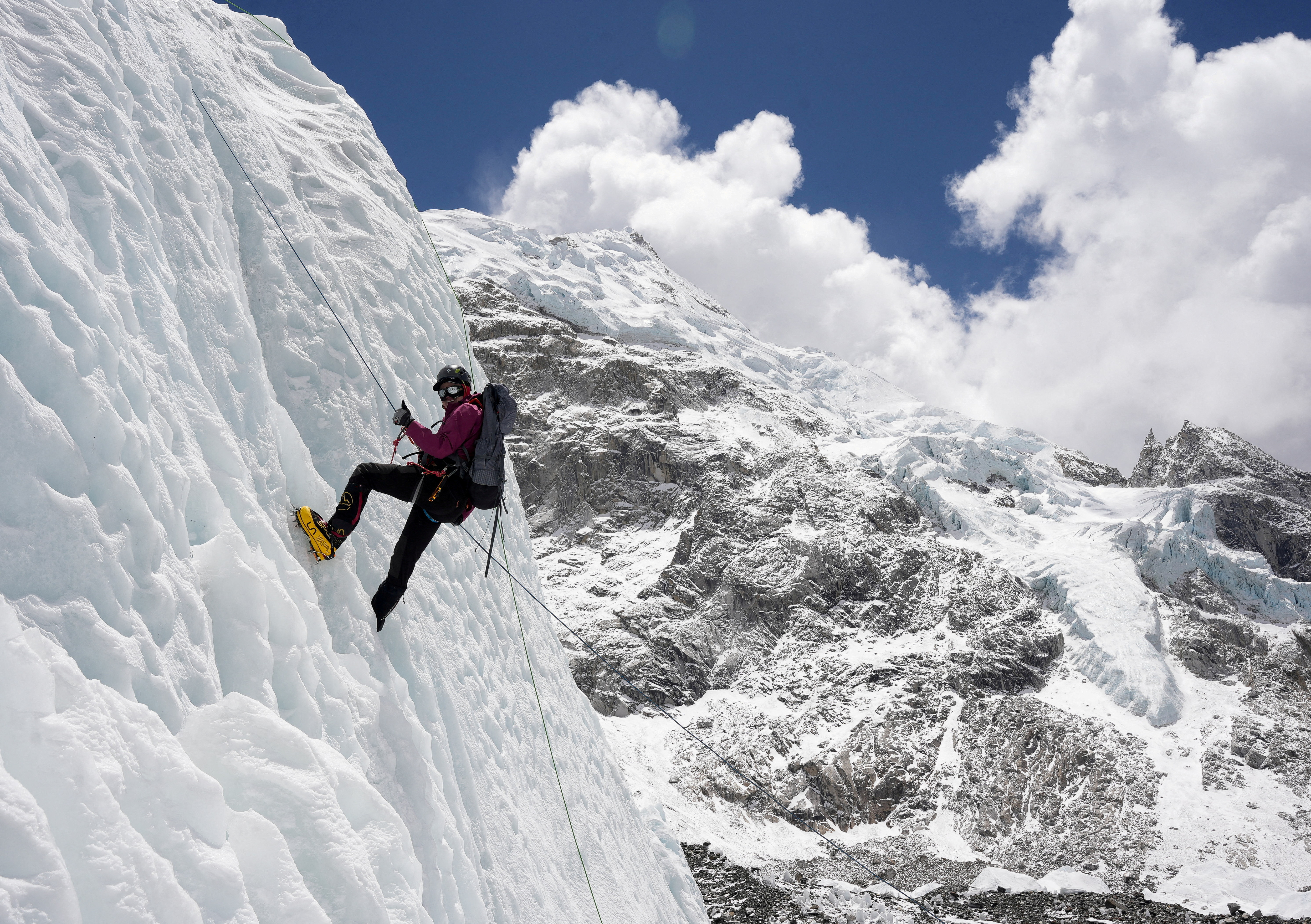 FILE PHOTO: A mountaineer holds on to the rope during an ice climbing session at Everest base camp