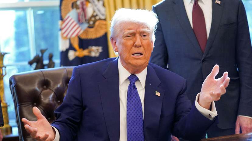 U.S. President Donald Trump signs an executive order in the Oval Office at the White House in Washington, D.C.