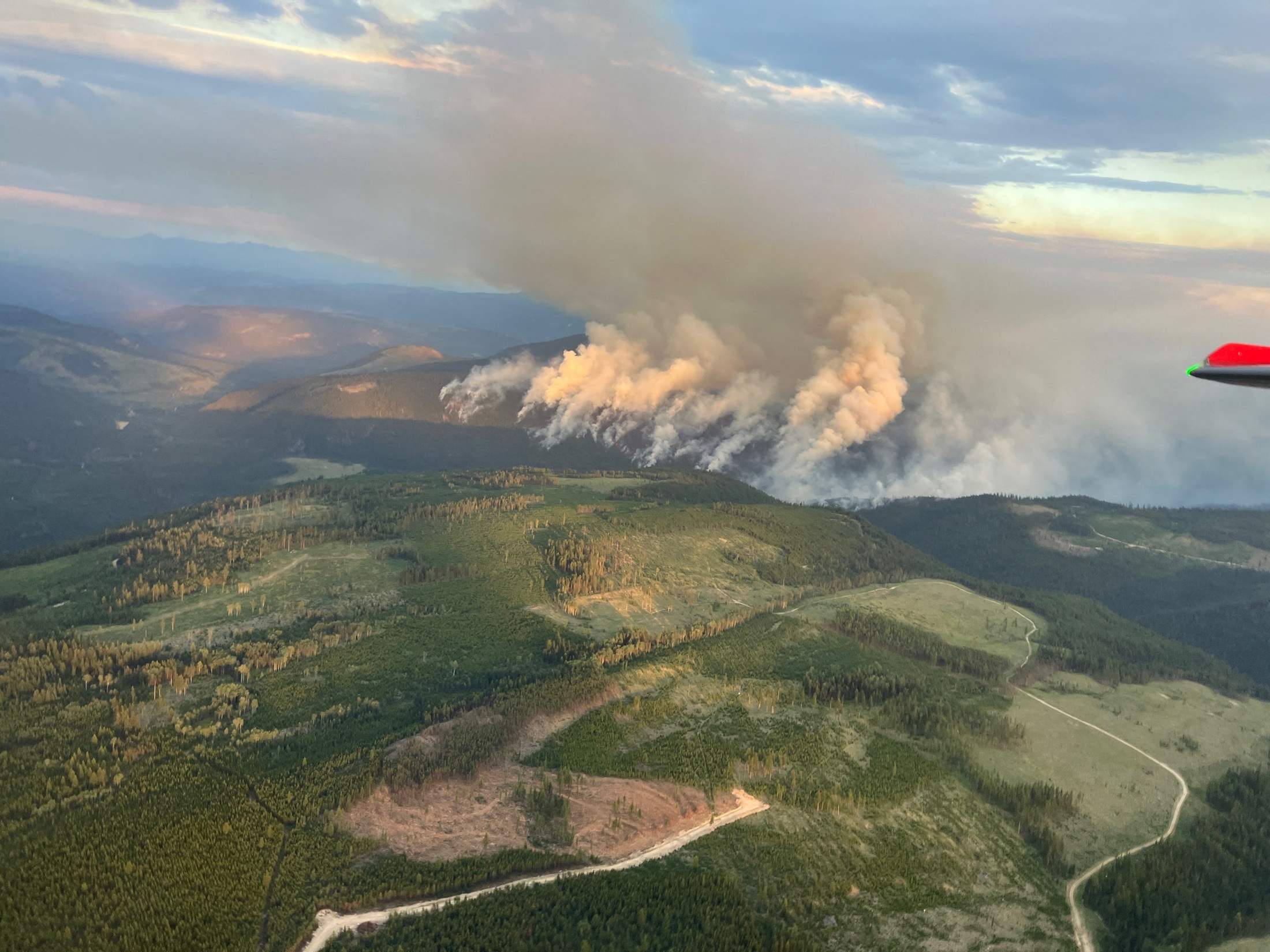 Smoke rises from the Lower Campbell Creek wildfire (K51472) wildfire northwest of Beaverdell