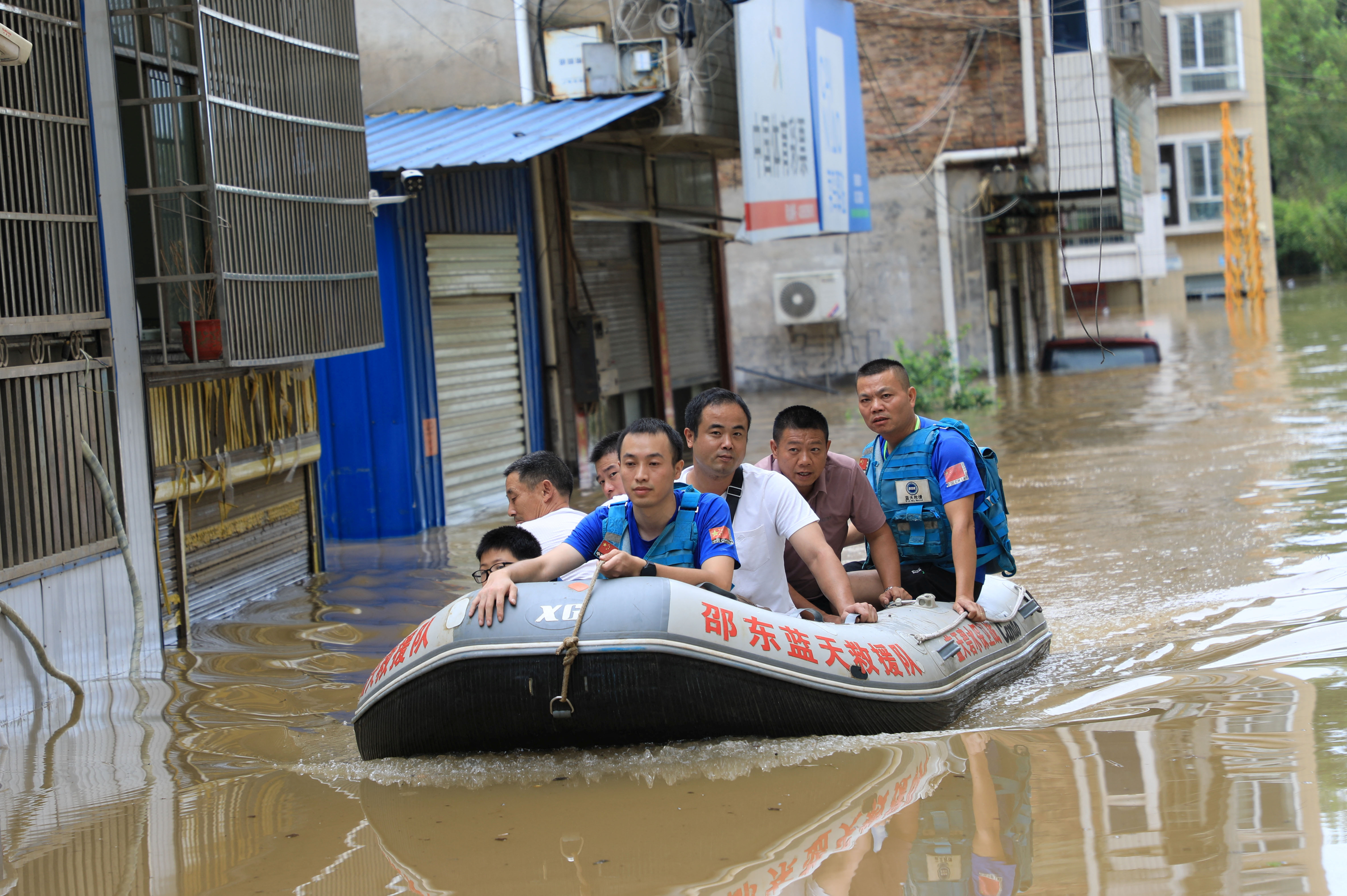 Rescue workers evacuate residents stranded by floodwaters in Shaodong