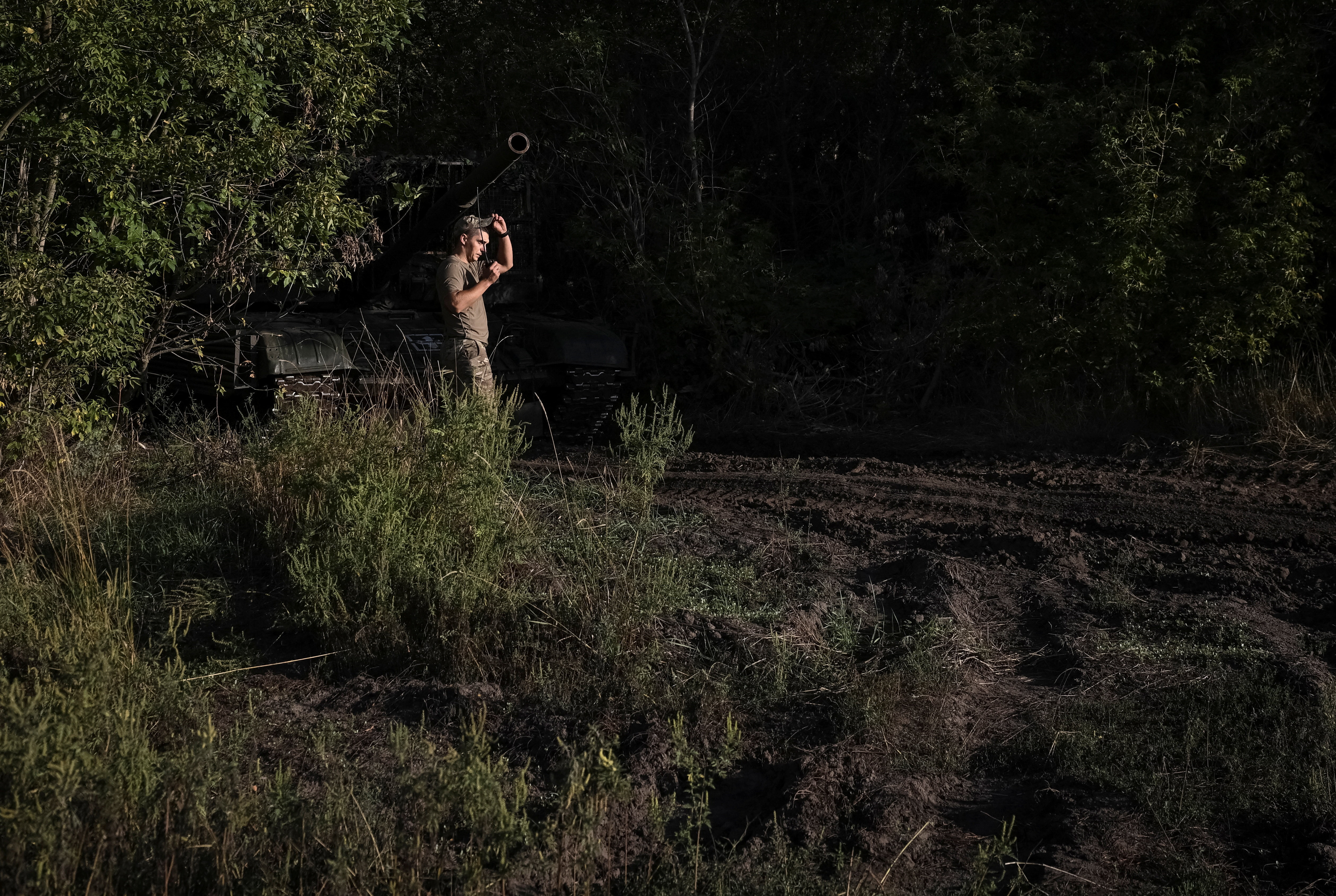 Ukrainian serviceman prepare a tank to fire towards Russian troops at a position near a front line in Donetskk region