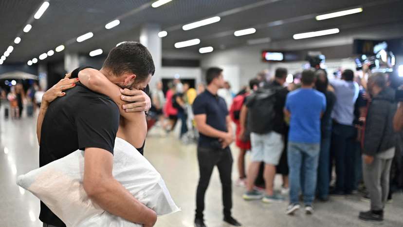 FILE PHOTO: A Brazilian migrant, deported from the U.S. under President Donald Trump's administration, is welcomed by his relative at the Confins airport in Belo Horizonte