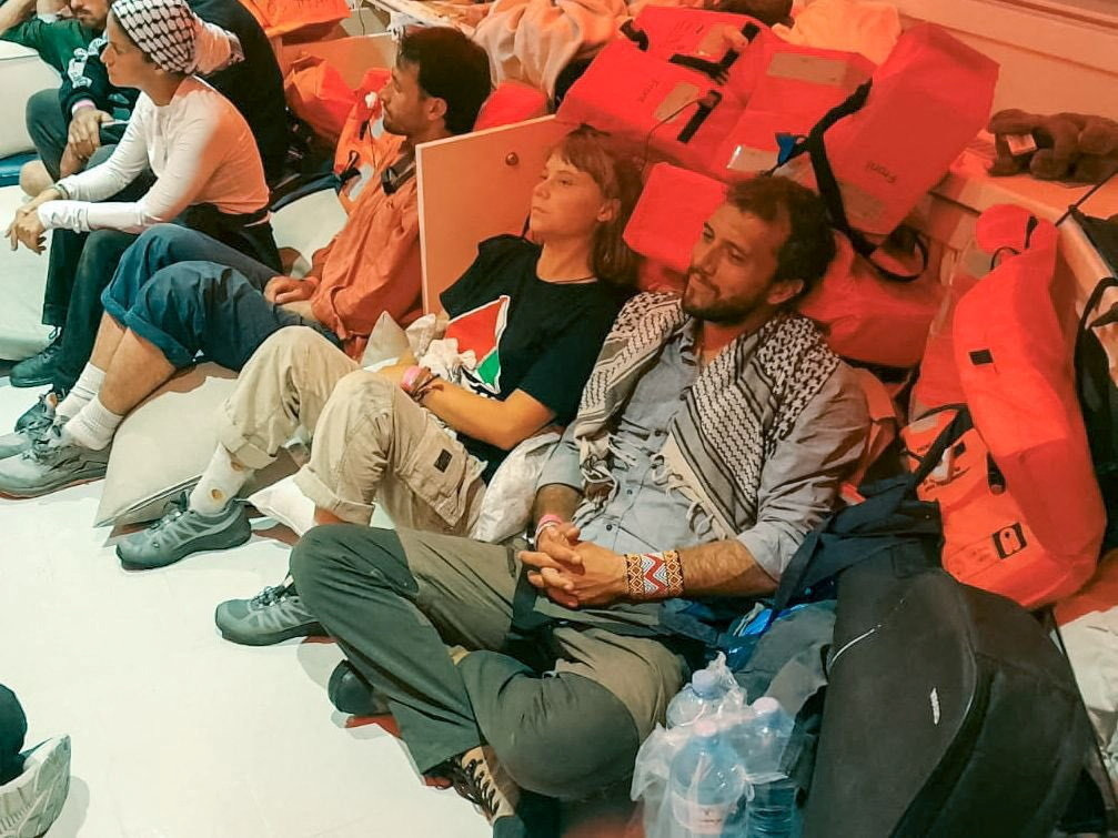 Swedish activist Greta Thunberg and Brazilian activist Thiago Avila sit in a vessel with members of the Global Sumud Flotilla, making their way to Israel