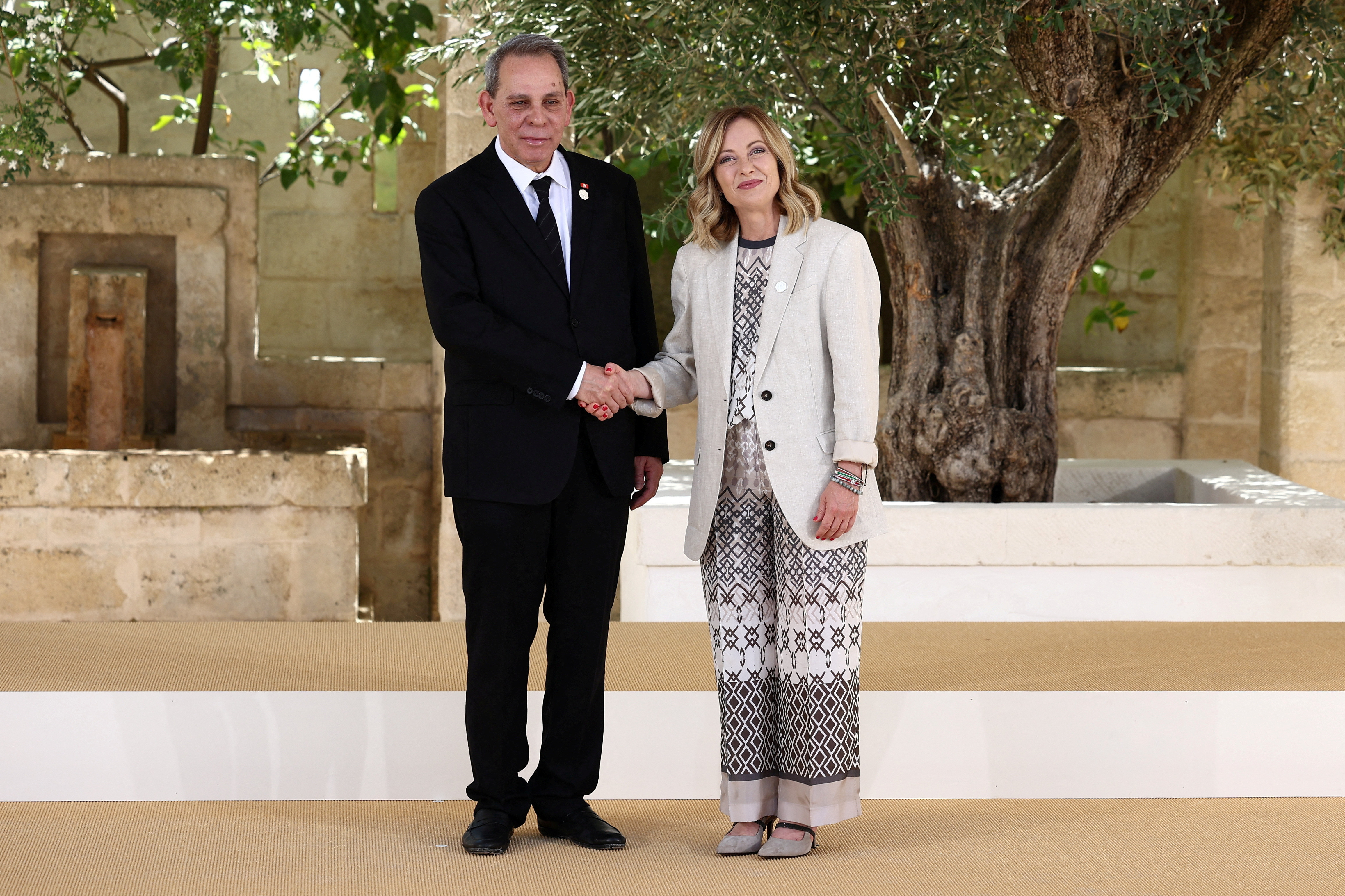 FILE PHOTO: Tunisia's Prime Minister Ahmed Hachani  is welcomed by Italian Prime Minister Giorgia Meloni on the second day of a G7 summit in Italy