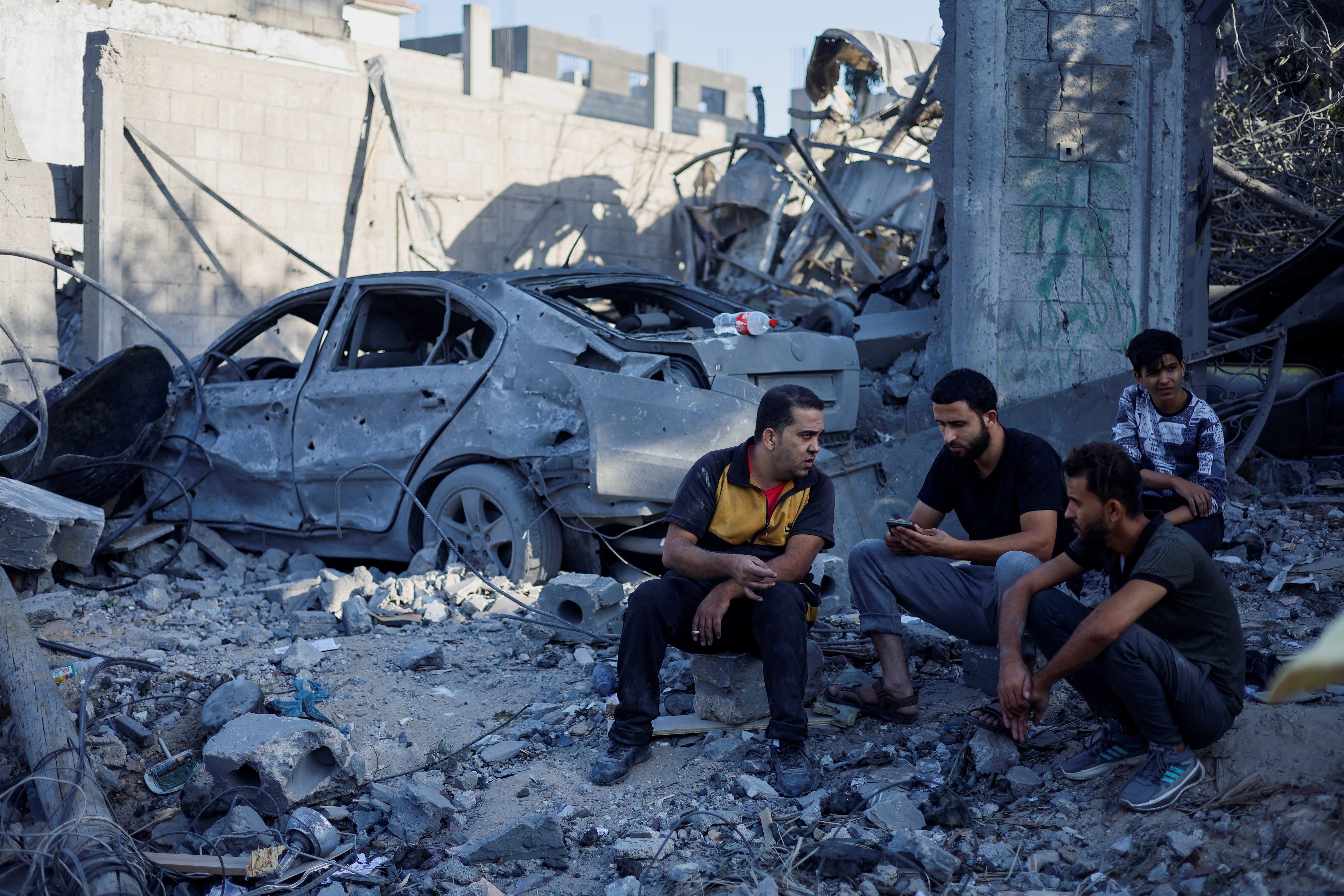 Palestinians gather at the site of Israeli strikes on houses, in Khan Younis