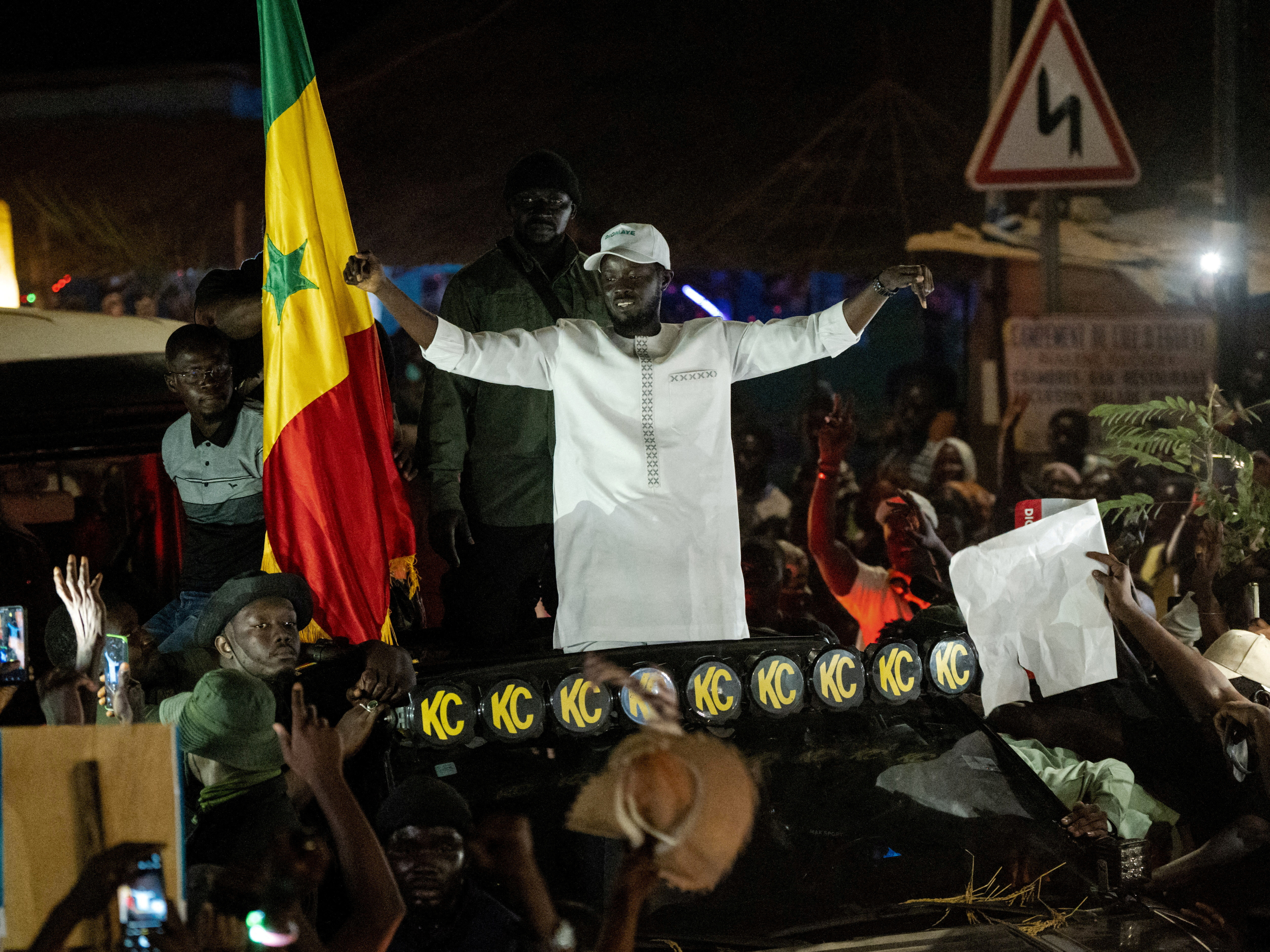 FILE PHOTO: Presidential candidate Bassirou Diomaye Faye cheers on supporters during his electoral campaign caravan in Ziguinchor