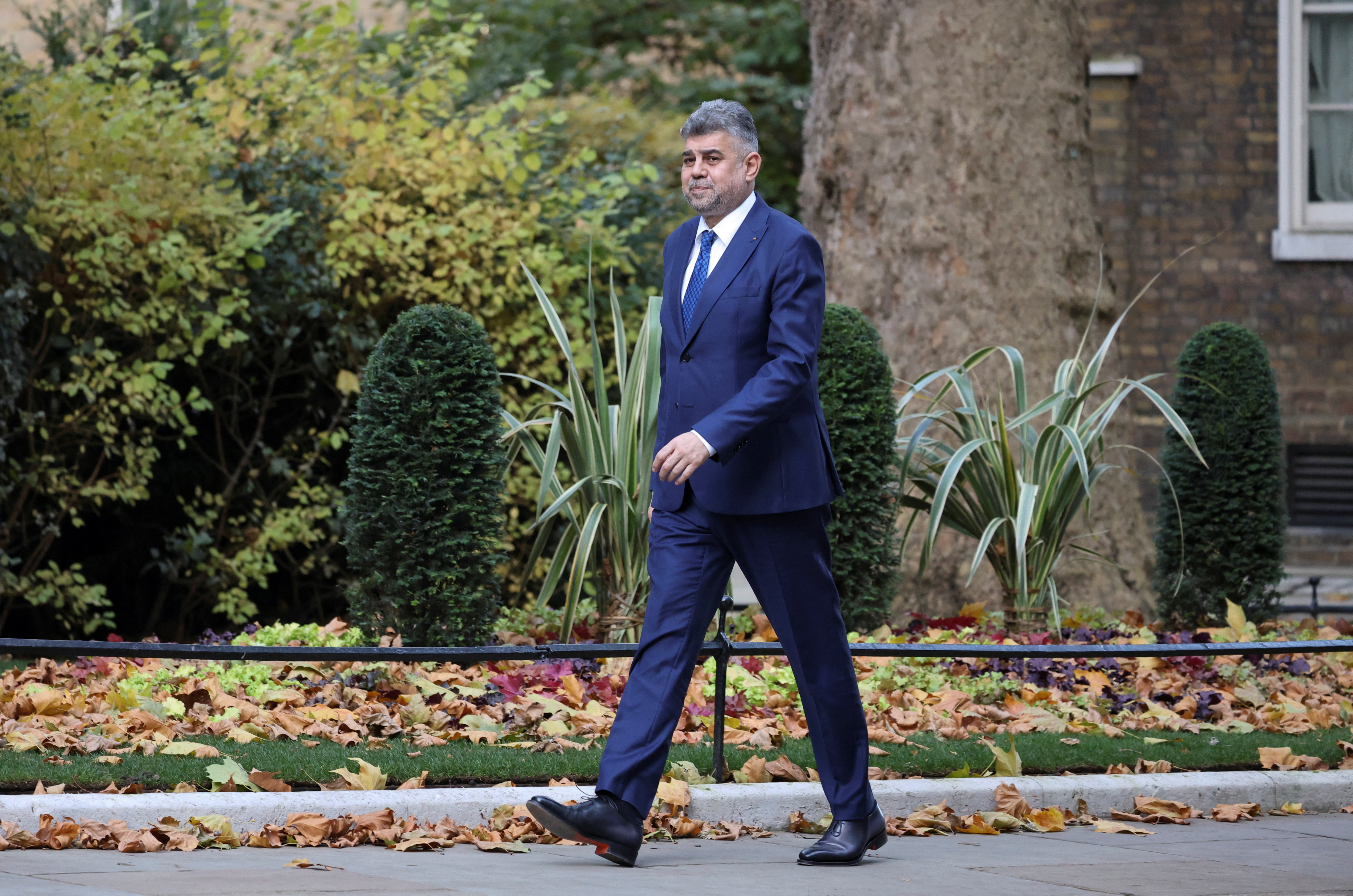 Romania's Prime Minister Marcel Ciolacu walks on Downing Street in London