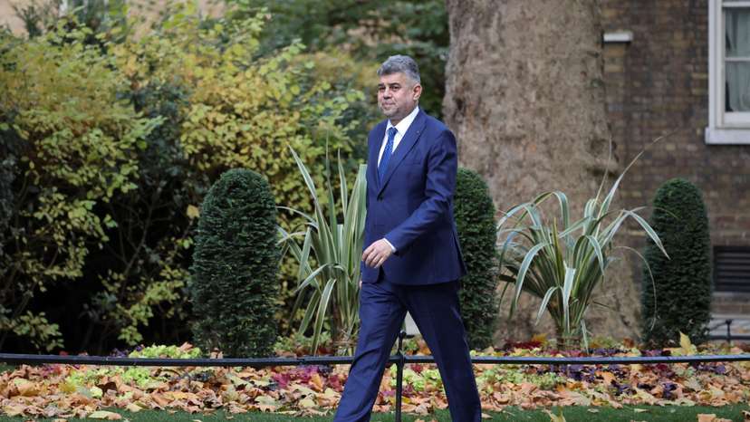 Romania's Prime Minister Marcel Ciolacu walks on Downing Street in London