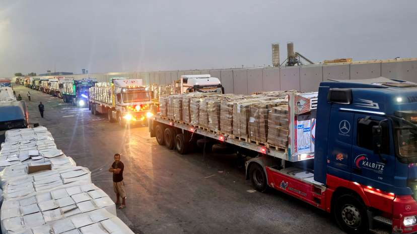 Trucks carrying humanitarian aid line up near the Rafah border crossing between Egypt and the Gaza Strip