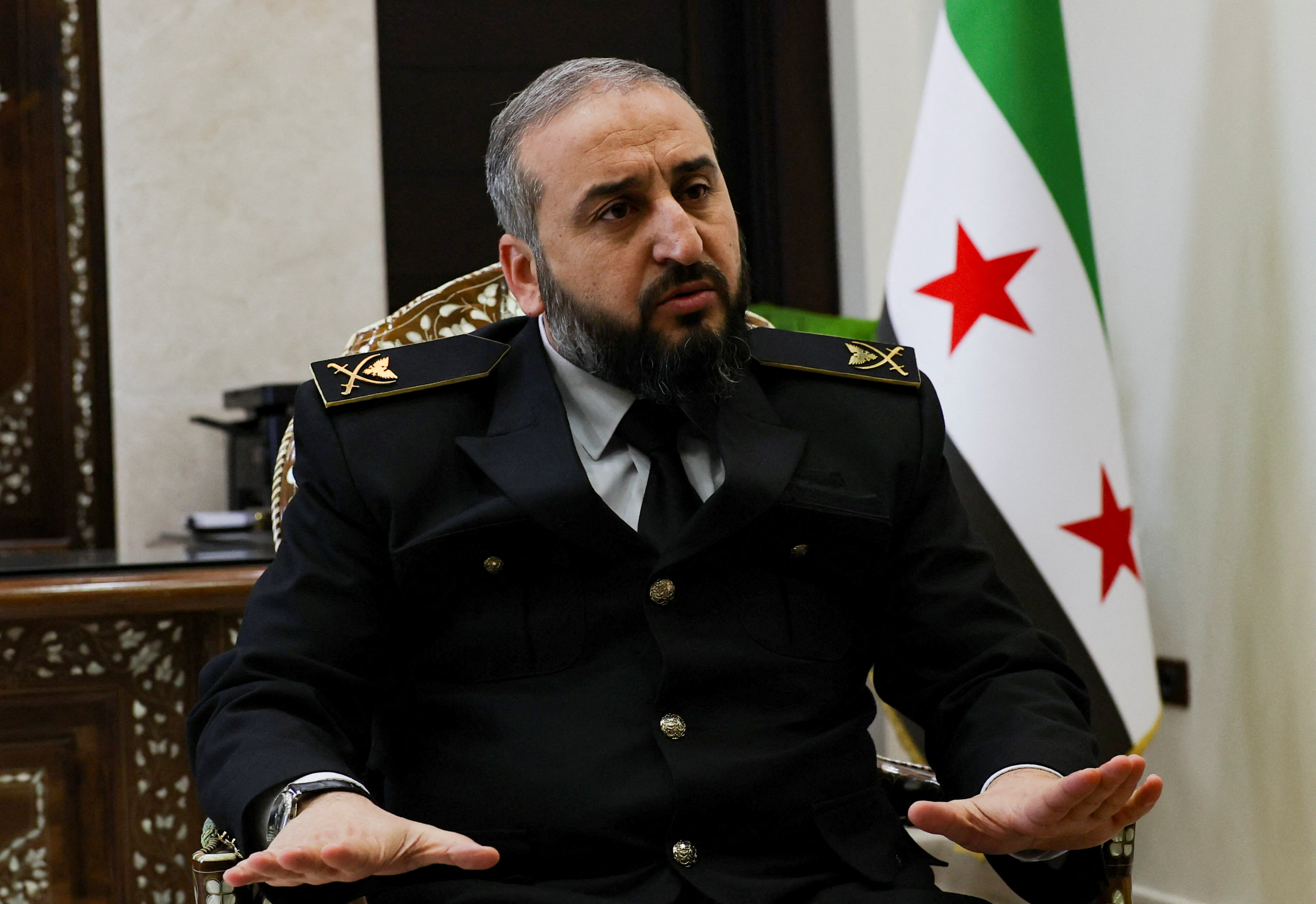 Syria's new defense minister Murhaf Abu Qasra attends an interview with Reuters in Damascus