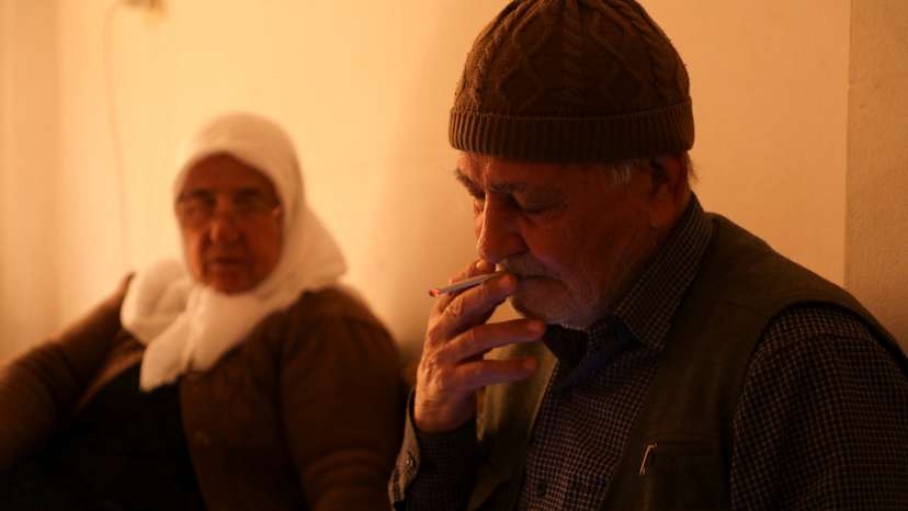 Alawite Qamishli resident Huseein Hamo, smokes a cigarette at their house in Qamishli