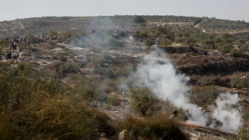 Israeli soldiers clash with Palestinian protesters who went out to pray on their land, in Beit Lid