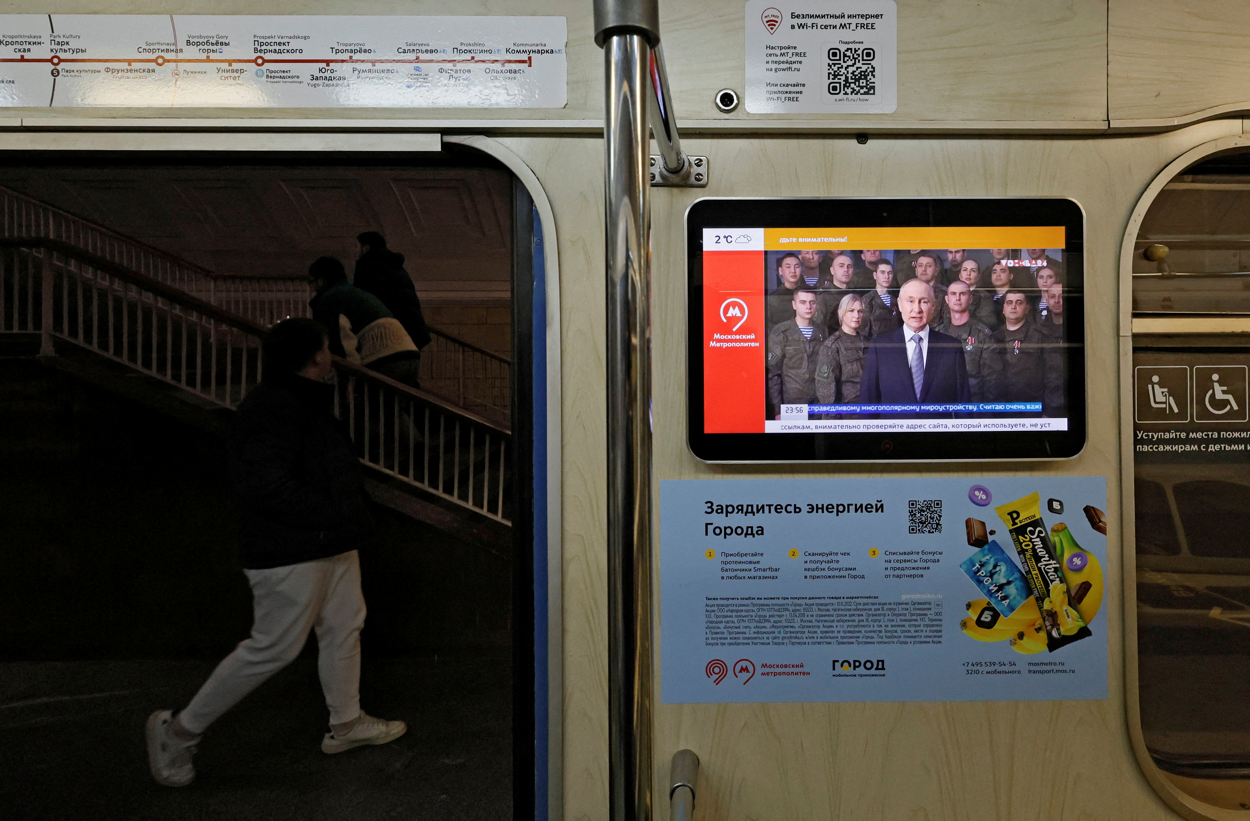A view shows a screen broadcasting Russian President Vladimir Putin's annual New Year address to the nation, in a subway train in Moscow